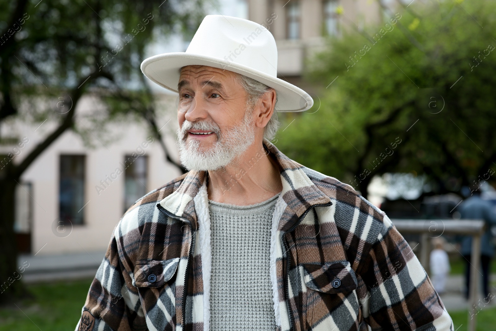 Photo of Portrait of handsome senior man walking outdoors