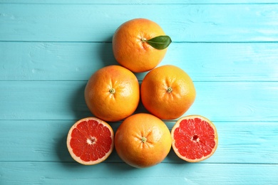 Fresh tasty grapefruits on color background, flat lay