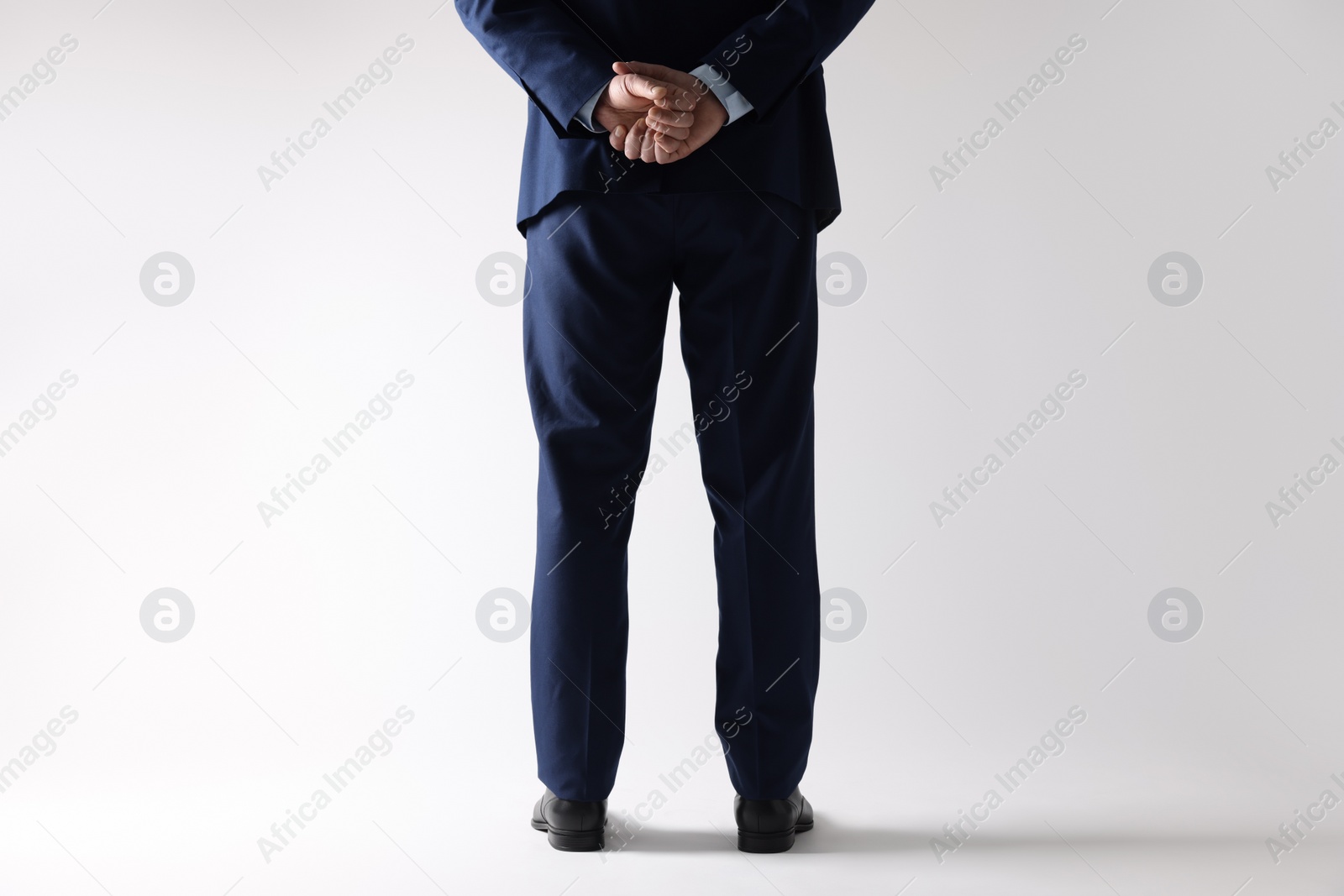 Photo of Businessman in leather shoes on white background, closeup