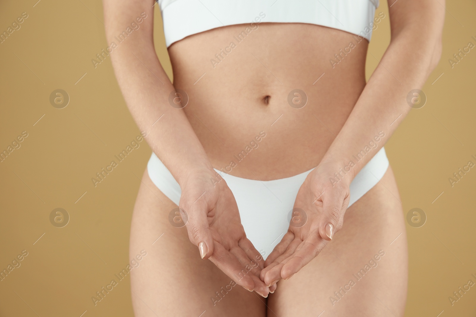 Photo of Gynecology. Woman in underwear on beige background, closeup