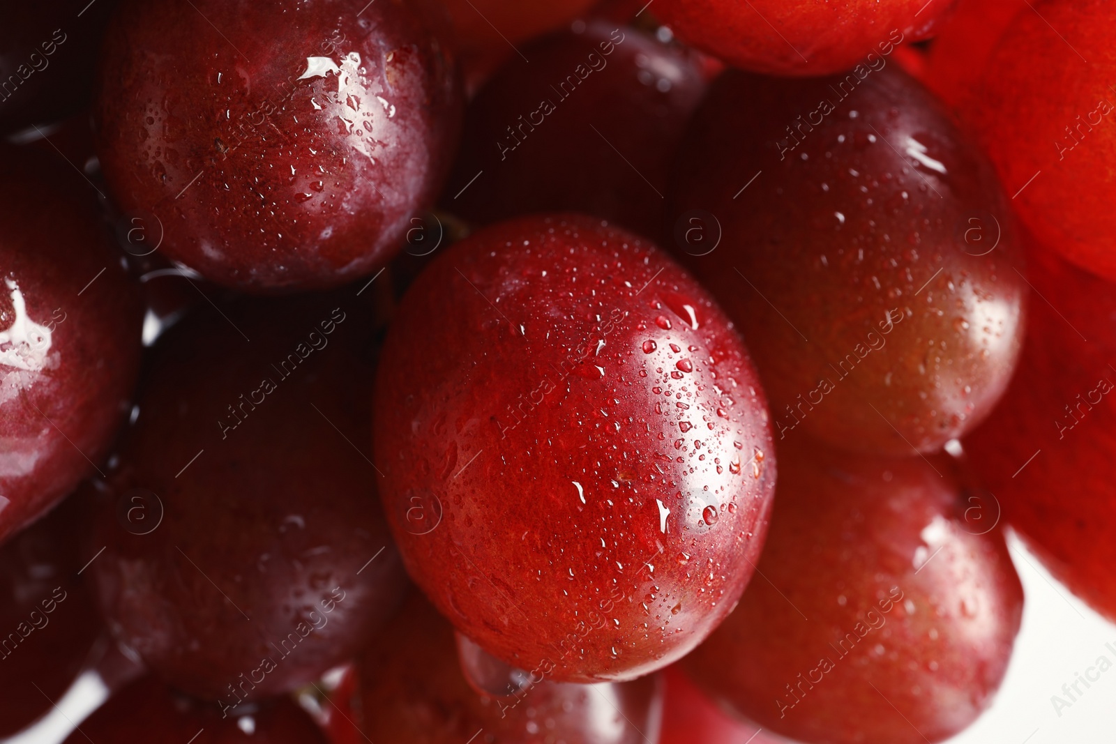 Photo of Bunch of red fresh ripe juicy grapes as background. Closeup view