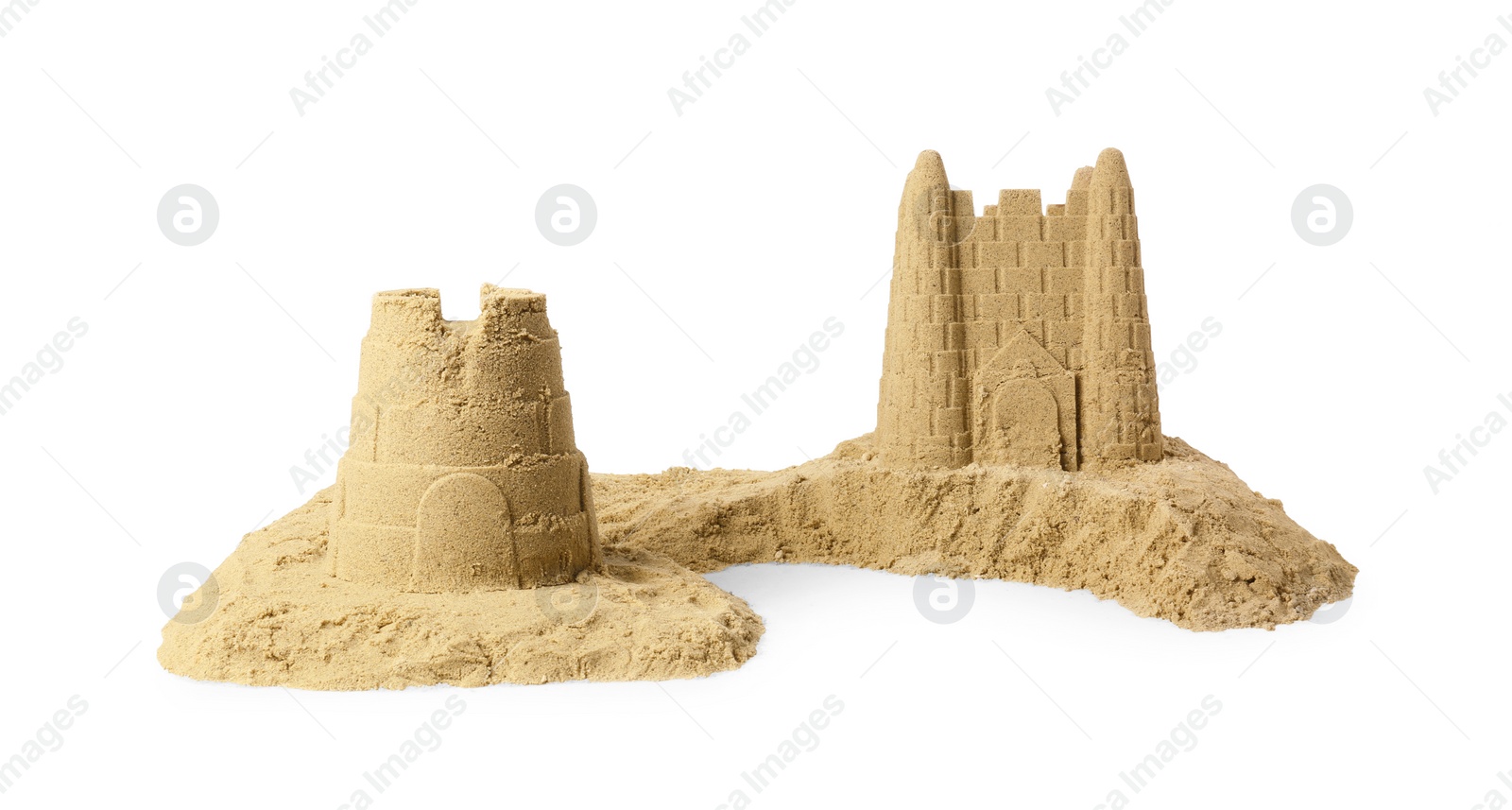 Photo of Pile of sand with beautiful castles isolated on white