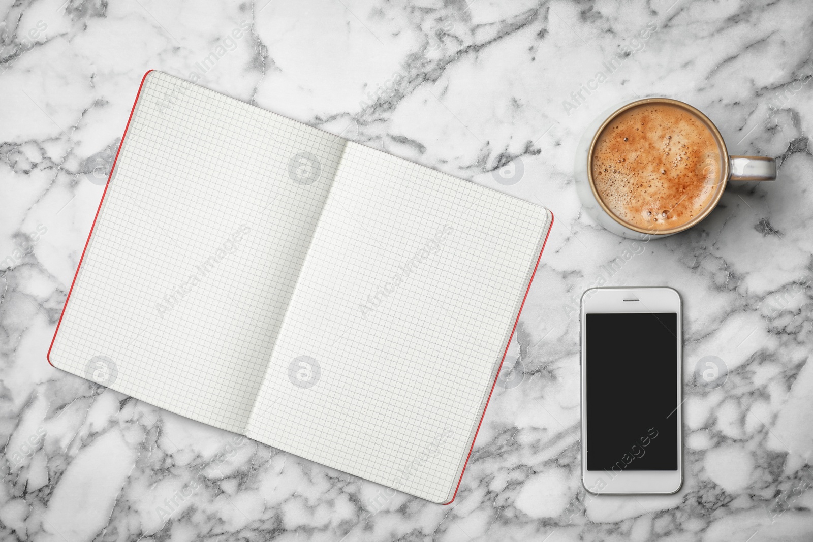 Photo of Flat lay composition with notebook, cup of aromatic coffee and mobile phone on marble background