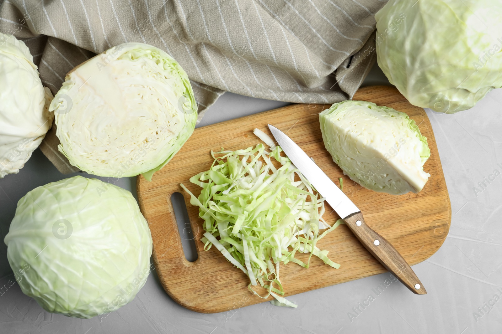 Photo of Fresh ripe cabbages on grey table, flat lay