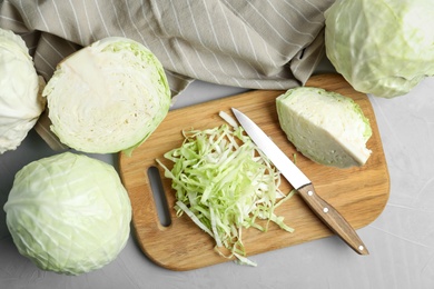 Photo of Fresh ripe cabbages on grey table, flat lay