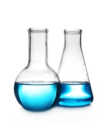 Laboratory glassware with liquid on table against white background. Chemical analysis