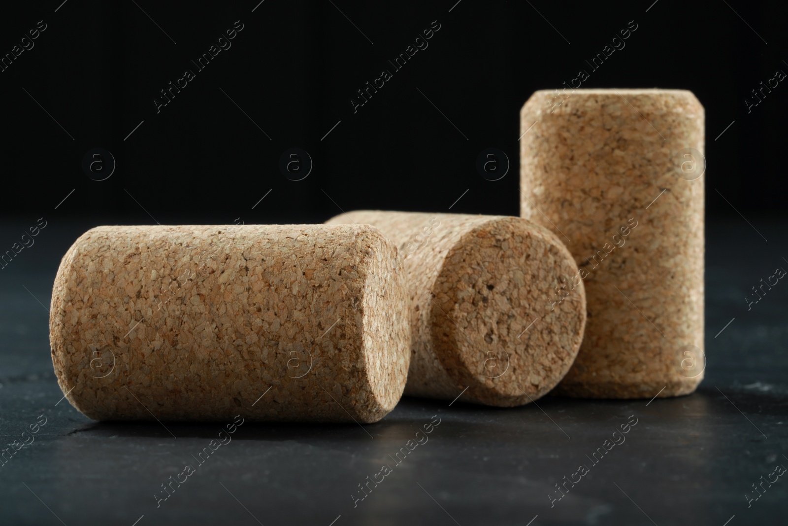 Photo of Corks of wine bottles on grey table, closeup