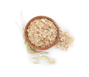 Wooden bowl with oatmeal and floret branches isolated on white, top view