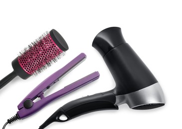 Image of Hair dryer, straightener and round brush on white background