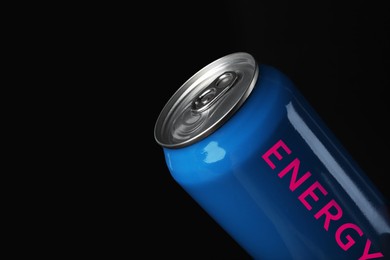 Can of energy drink on black background