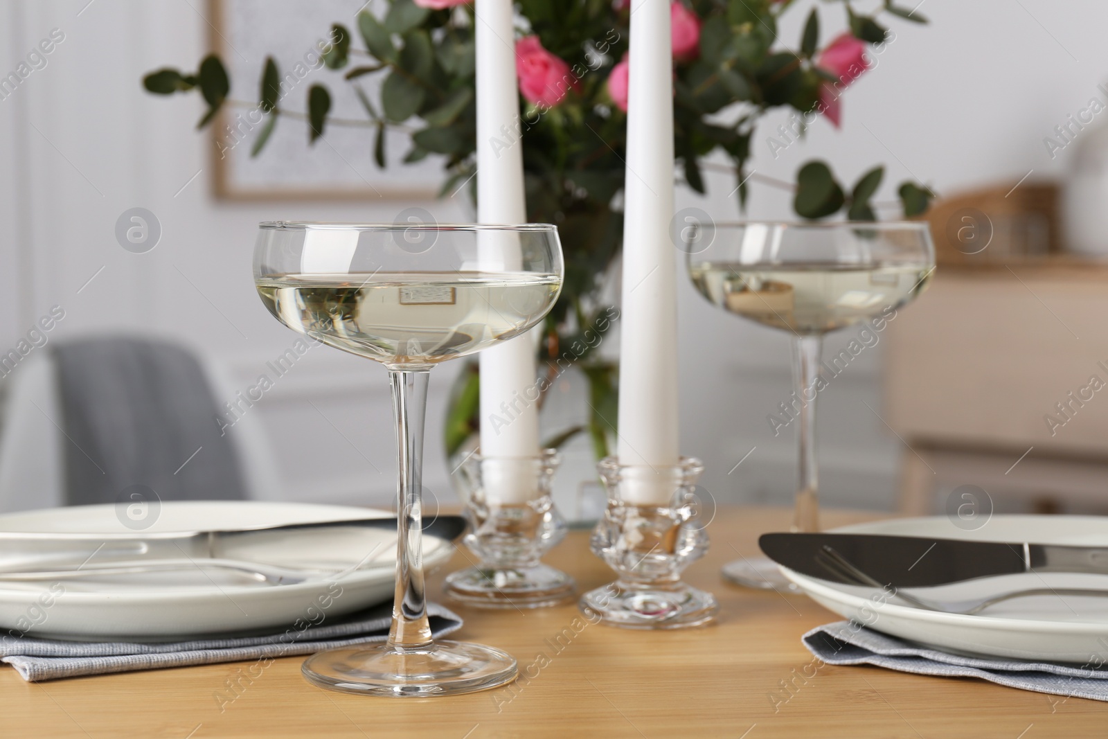 Photo of Romantic table setting with candles and flowers