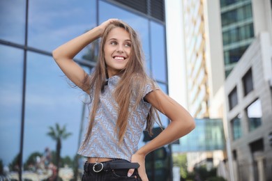 Portrait of beautiful young woman on city street