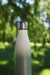 Photo of Closeup view of thermo bottle in park