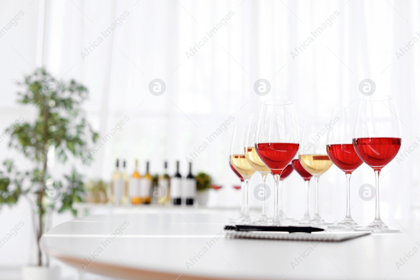 Photo of Glasses with delicious wine on table indoors