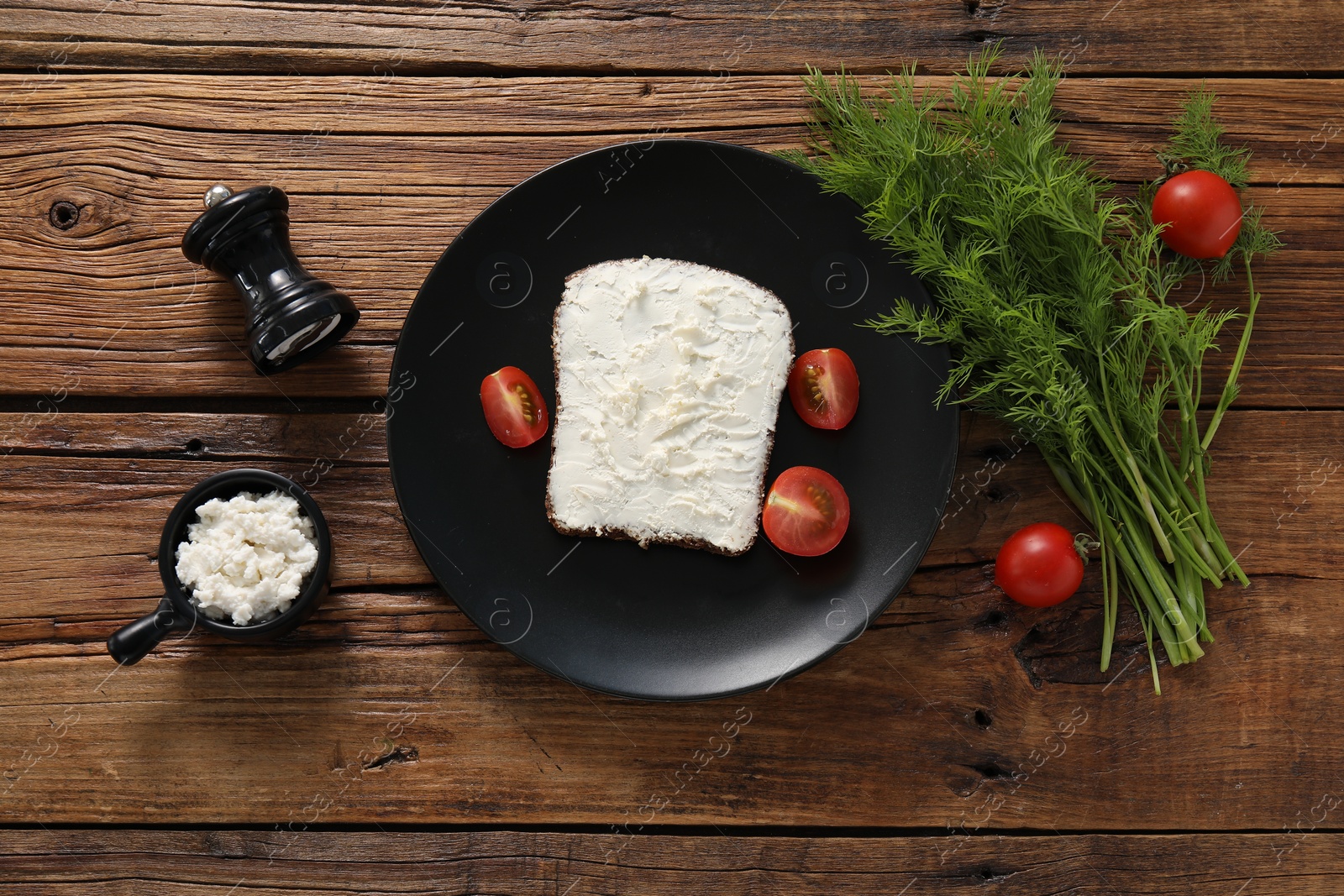 Photo of Delicious bruschetta with ricotta cheese, tomatoes and dill on wooden table, flat lay