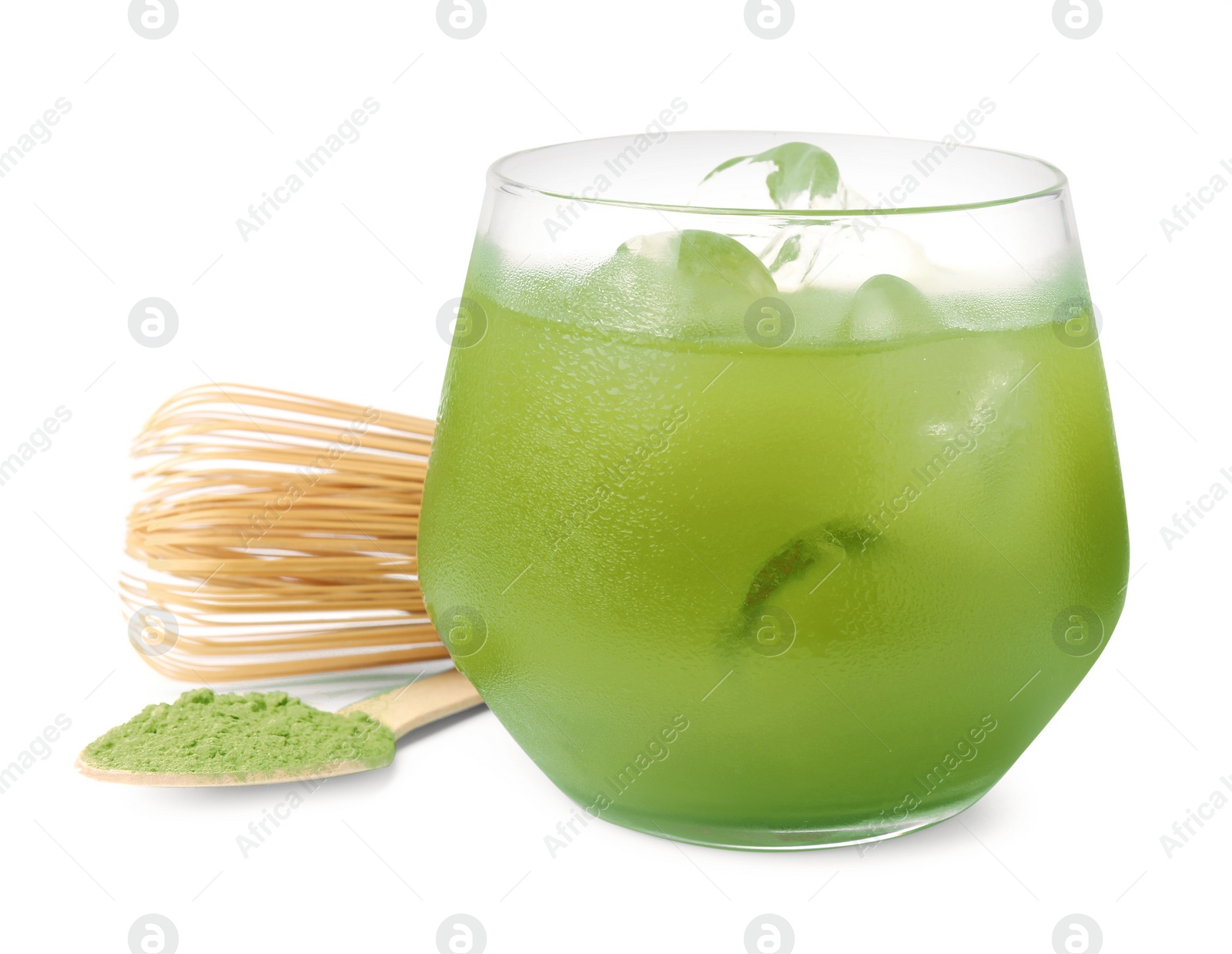 Photo of Glass of delicious iced green matcha tea, spoon with powder and bamboo whisk isolated on white