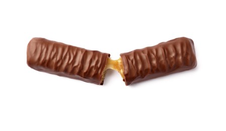 Pieces of chocolate bar with caramel on white background, top view