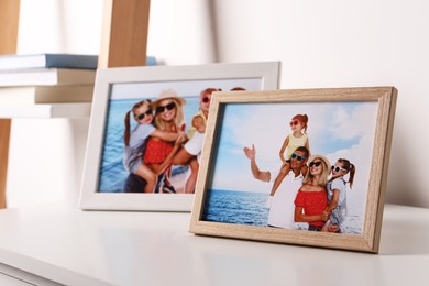 Photo of Frames with family photos on white table indoors