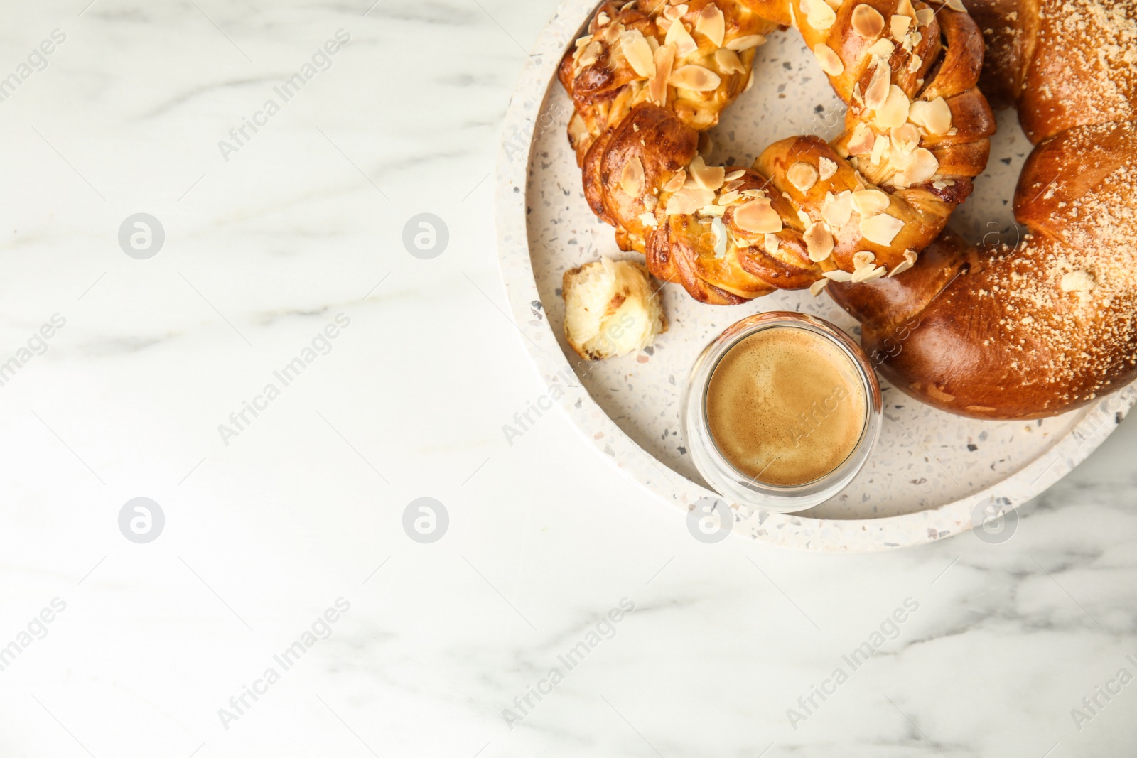 Photo of Fresh tasty pastries and coffee on white marble table, top view. Space for text