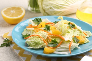 Photo of Tasty salad with Chinese cabbage and products on beige table, closeup