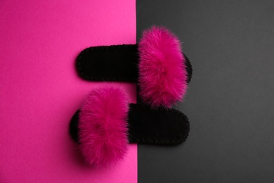 Photo of Pair of soft slippers on color background, flat lay