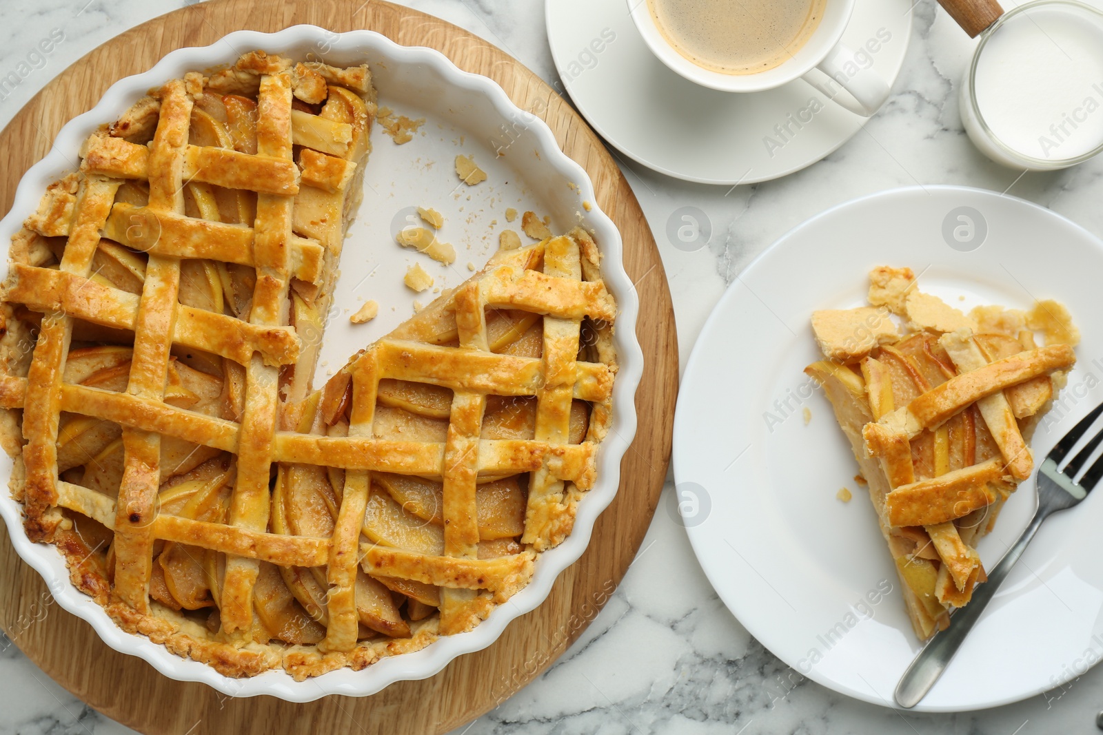 Photo of Tasty homemade quince pie served on white marble table, flat lay