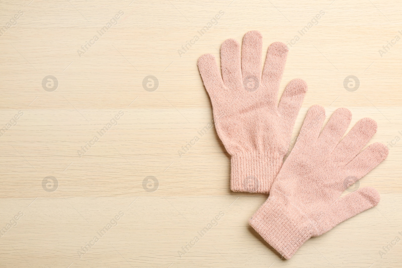 Photo of Stylish pink gloves on white wooden background, flat lay. Space for text