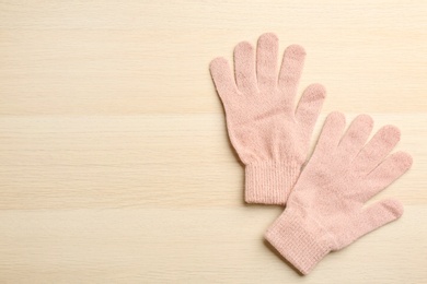 Photo of Stylish pink gloves on white wooden background, flat lay. Space for text