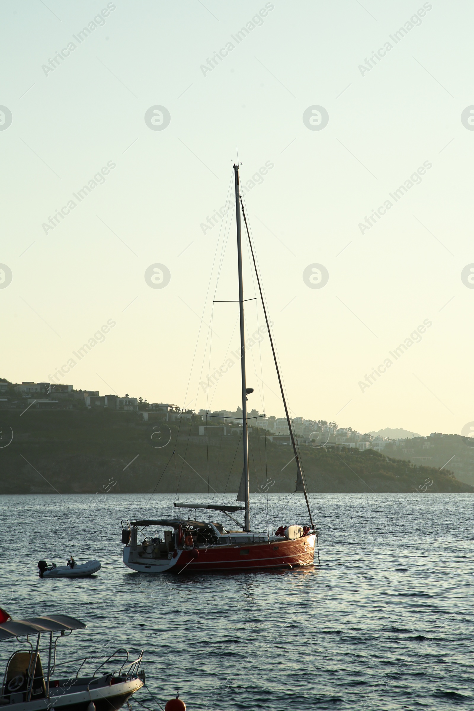 Photo of Beautiful view of calm sea with yacht and boats on summer day