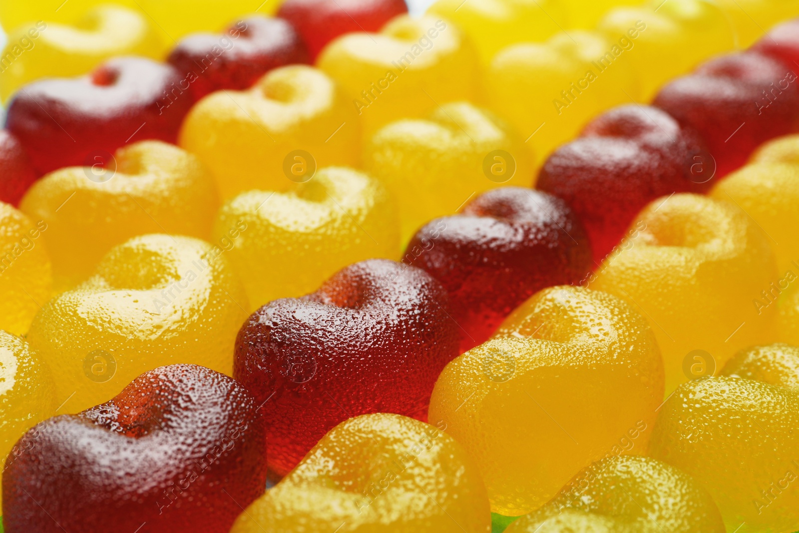 Photo of Delicious gummy cherry candies as background, closeup