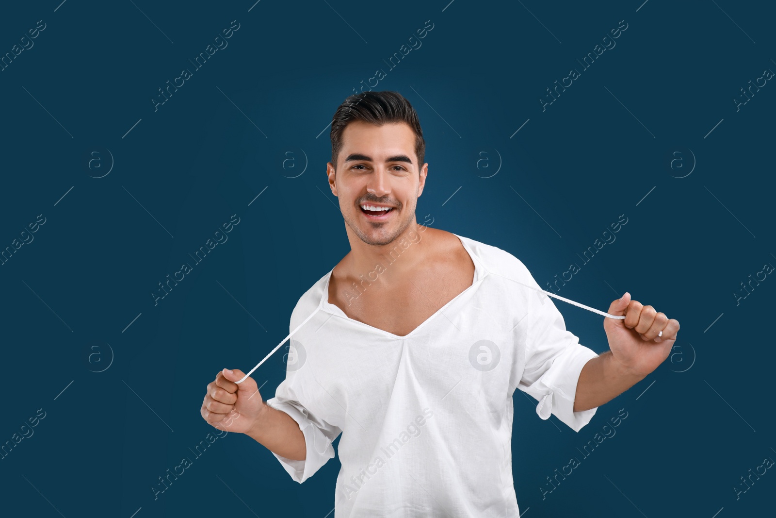 Photo of Portrait of handsome young man on blue background