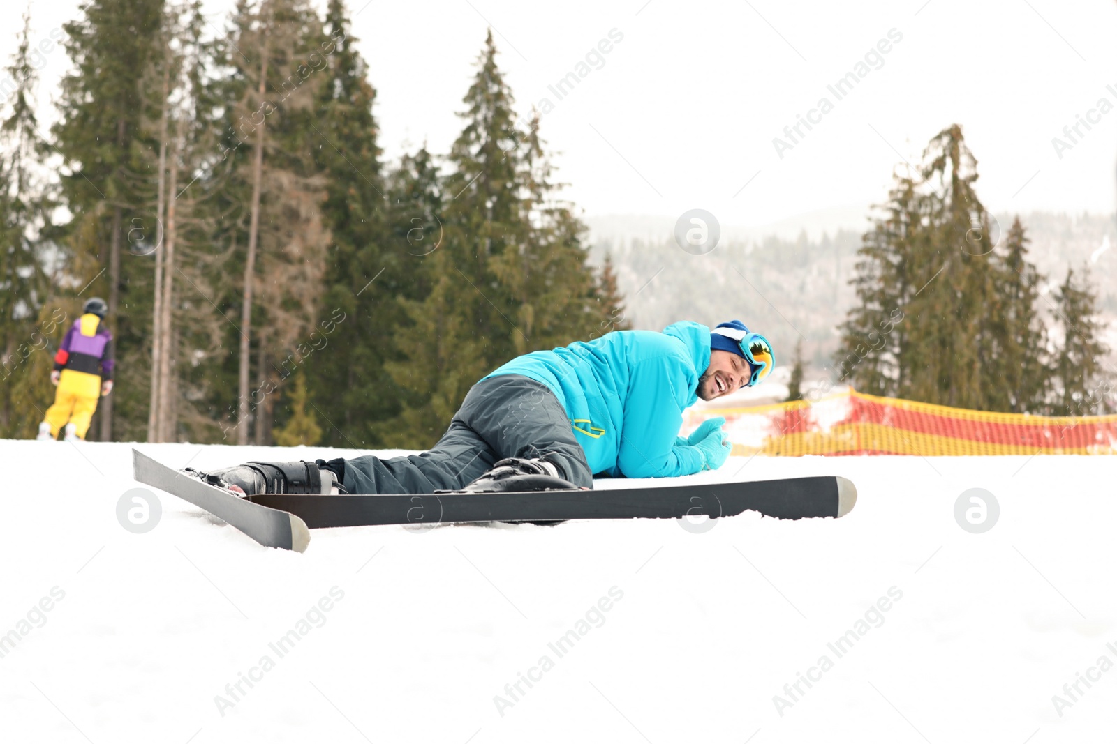 Photo of Clumsy skier on slope at resort. Winter vacation