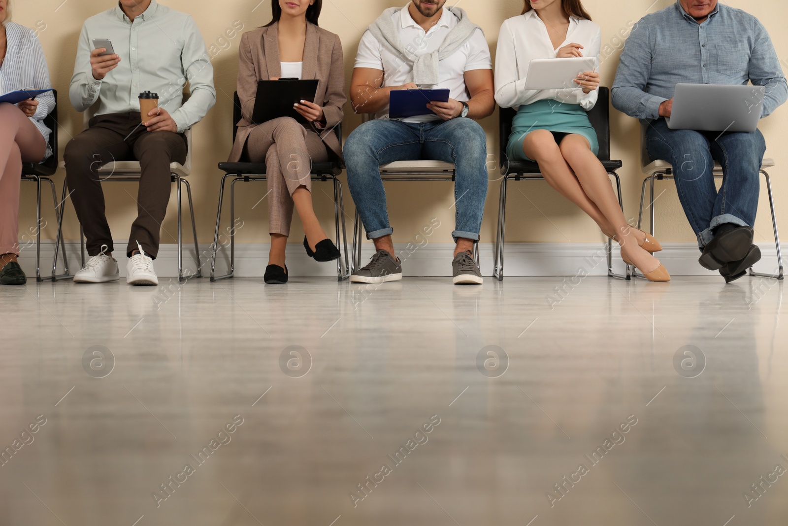 Photo of People waiting for job interview in office, closeup