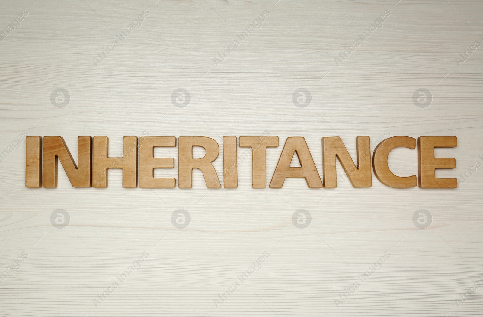 Photo of Word Inheritance made with letters on wooden background, flat lay