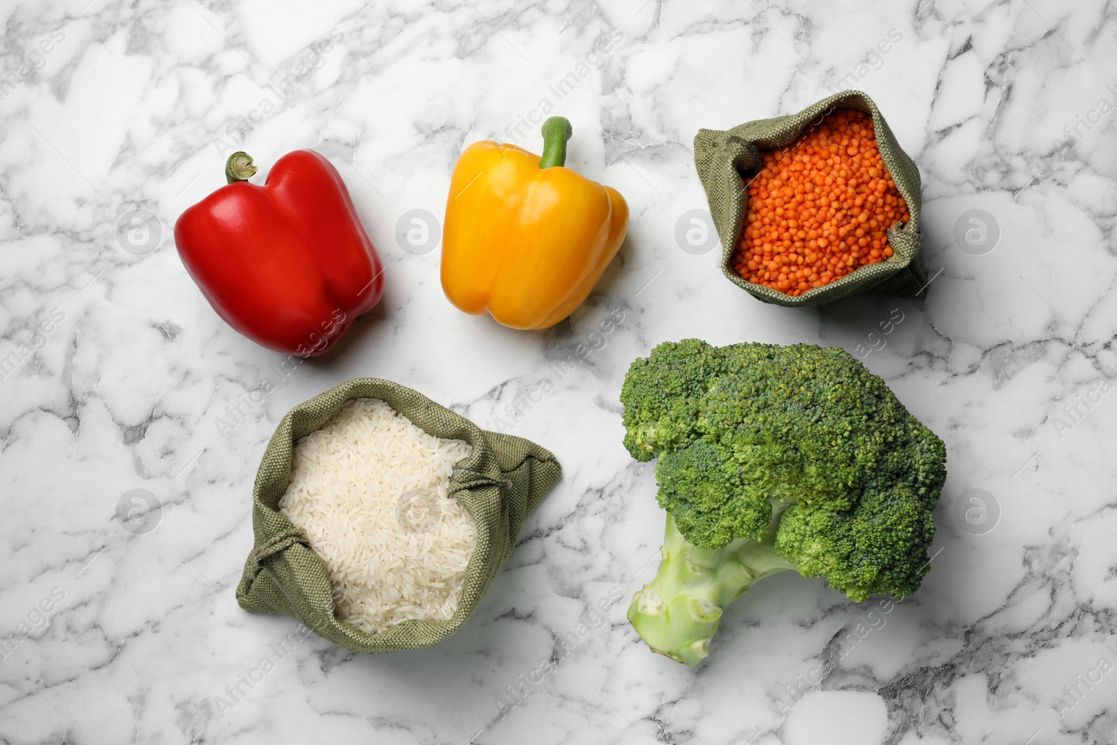 Photo of Fresh vegetables and seeds on white marble table, flat lay