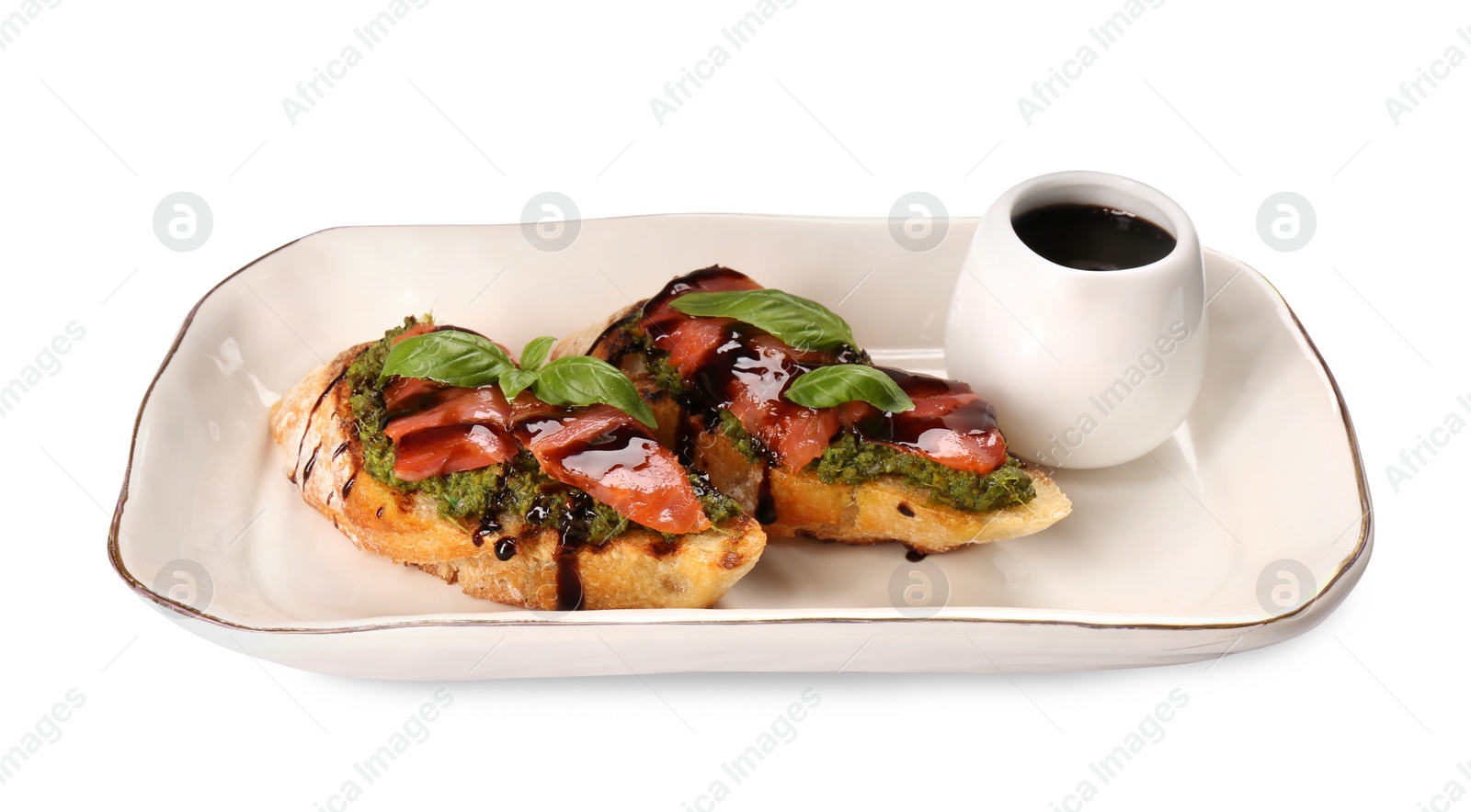 Photo of Delicious bruschettas with balsamic vinegar and toppings isolated on white