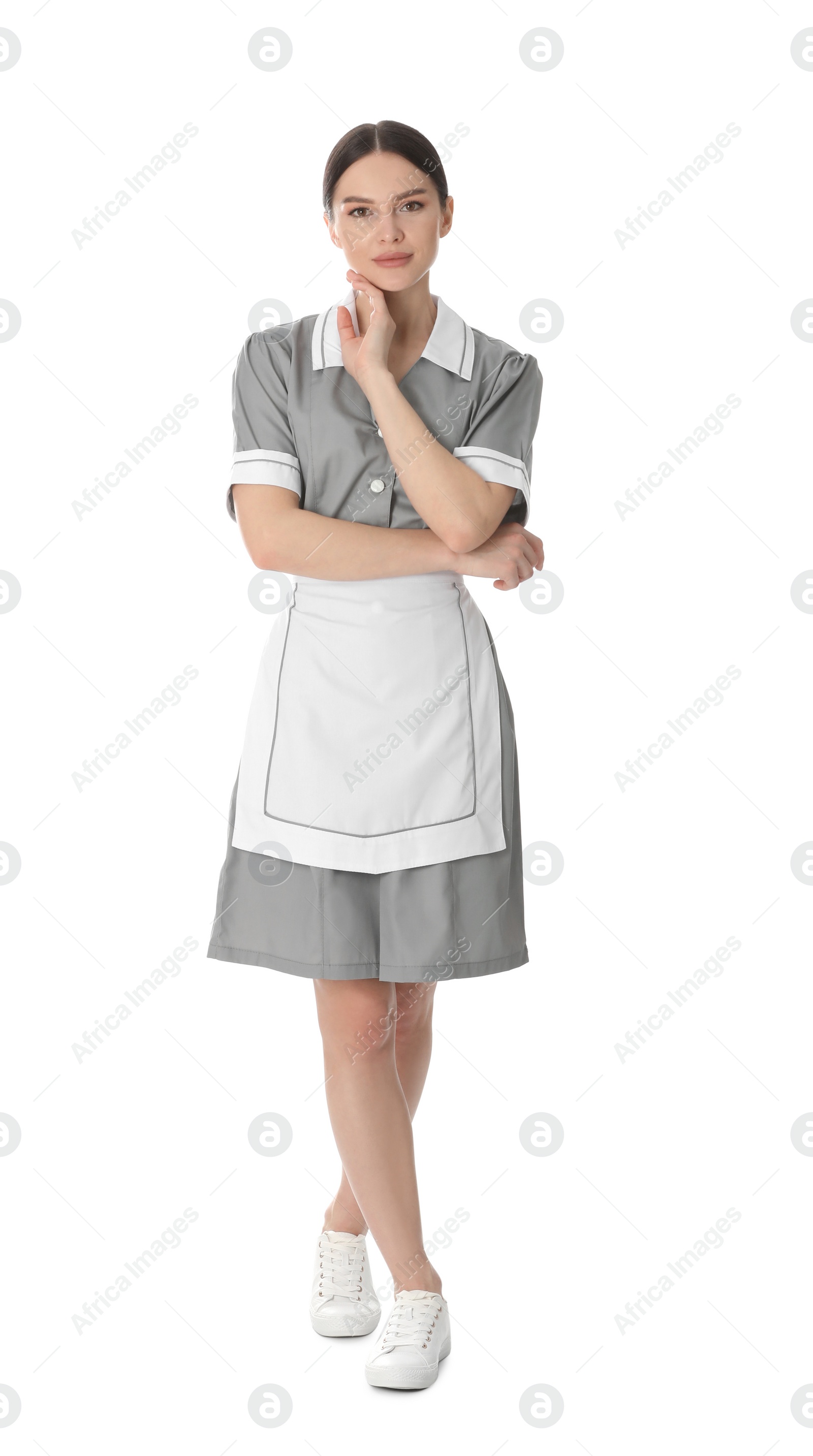 Photo of Young chambermaid in uniform on white background