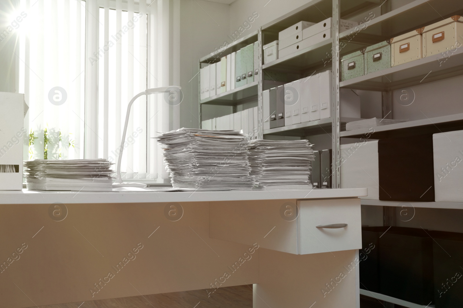 Photo of Stacks of documents on table in office