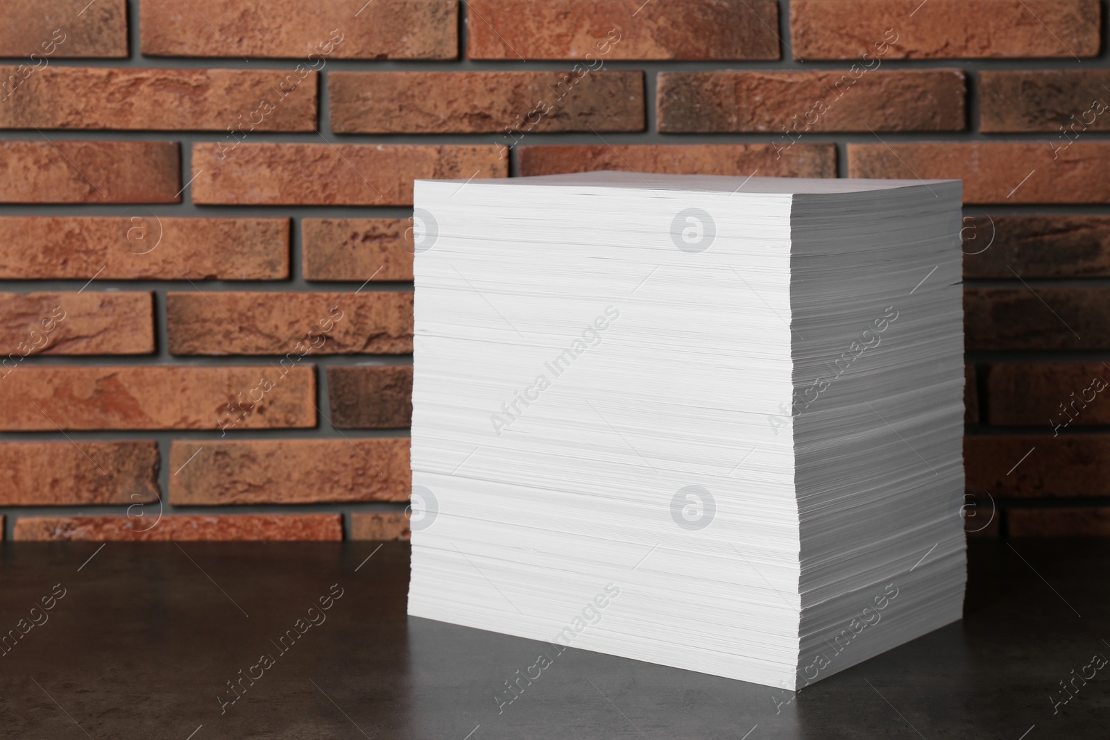 Photo of Stack of paper sheets on black table