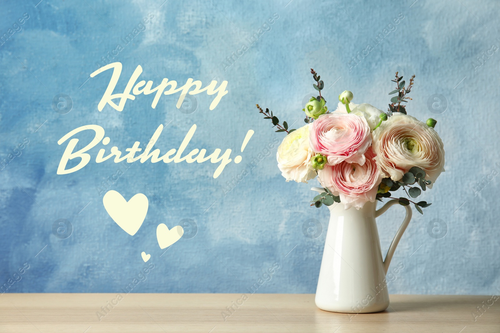 Image of Happy Birthday! Vase with beautiful spring ranunculus flowers on wooden table