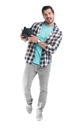 Photo of Handsome young man with piggy bank on white background