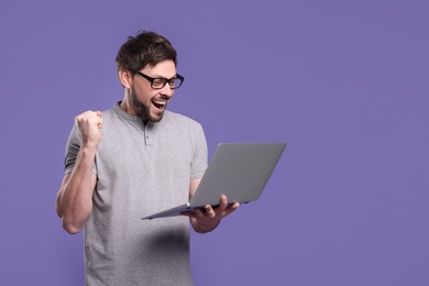 Photo of Emotional man with laptop on lilac background, space for text