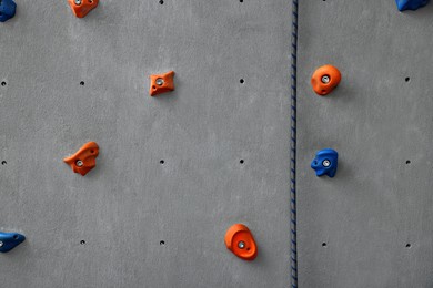 Photo of Colorful climbing wall with holds. Extreme sport