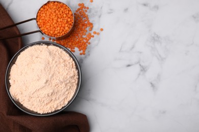 Lentil flour and seeds on white marble table, flat lay. Space for text