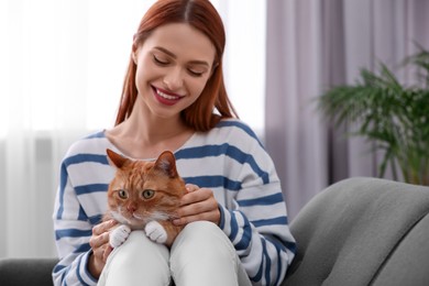 Happy woman with her cute cat at home