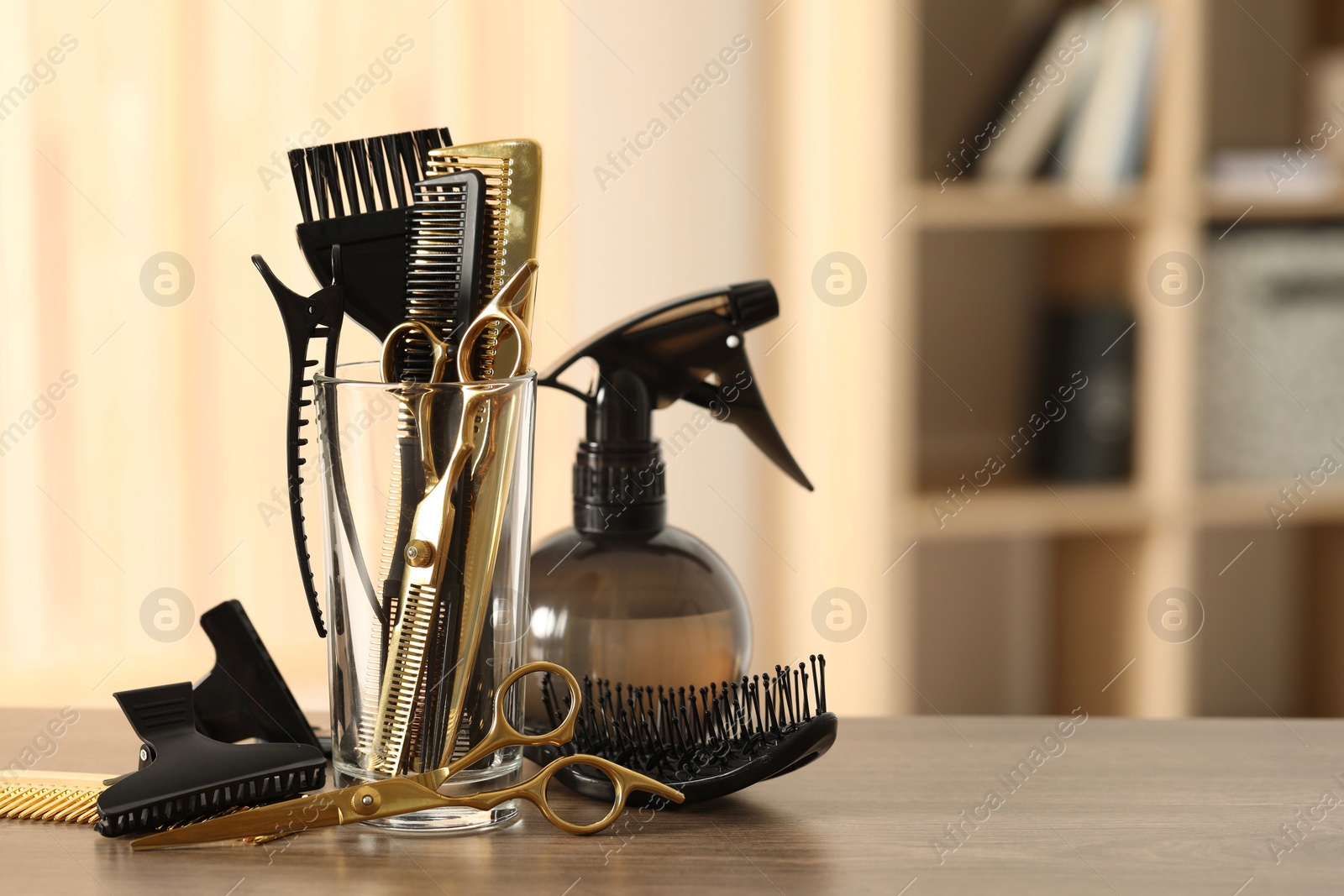 Photo of Set of hairdresser tools on table in salon, space for text
