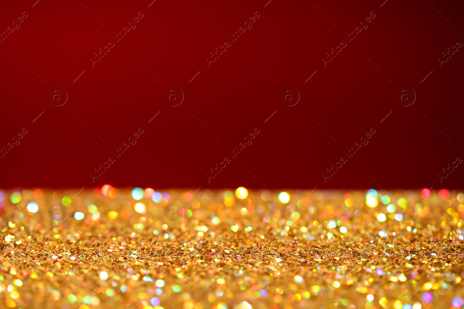 Photo of Many golden paillettes against color background. Space for text