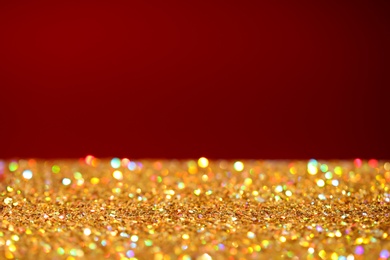 Photo of Many golden paillettes against color background. Space for text