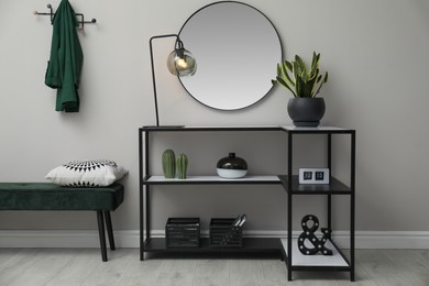 Photo of Hallway with stylish console table and mirror. Interior design