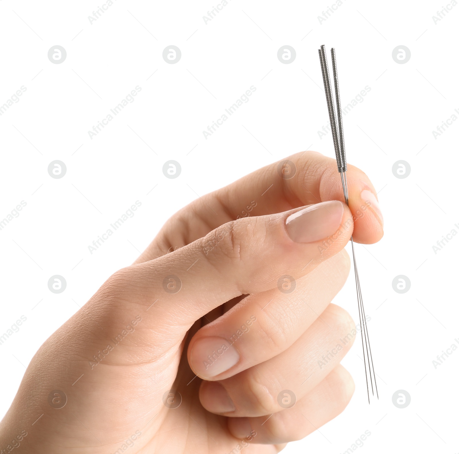 Photo of Woman holding needles for acupuncture on white background, closeup